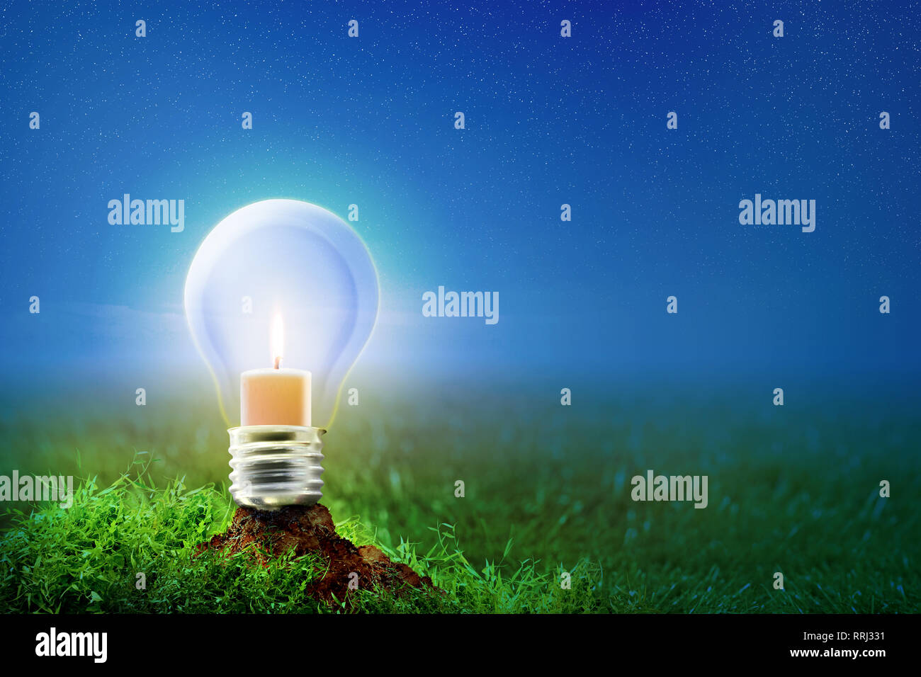 Burning candle inside light bulb on the soil in meadow at night with star on the sky background. Earth hour concept Stock Photo