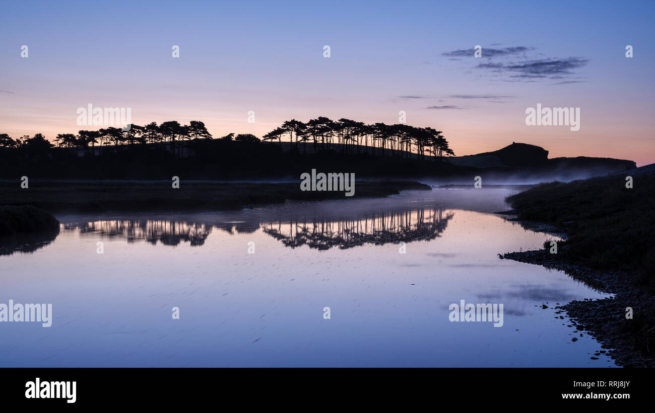 Twilight with a rising mist and perfect reflections on the River Otter at Budleigh Salterton, Devon, England, United Kingdom, Europe Stock Photo