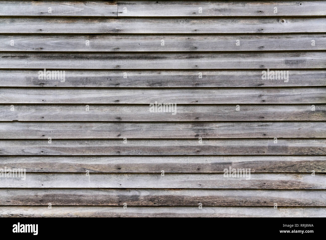 Old weathered horizontal wood exterior siding Stock Photo