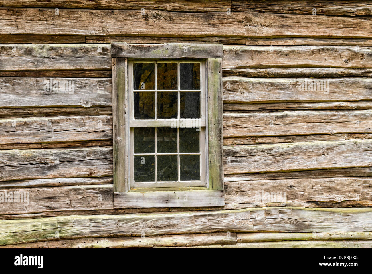 Exterior of old weathered window in a rustic log cabin Stock Photo