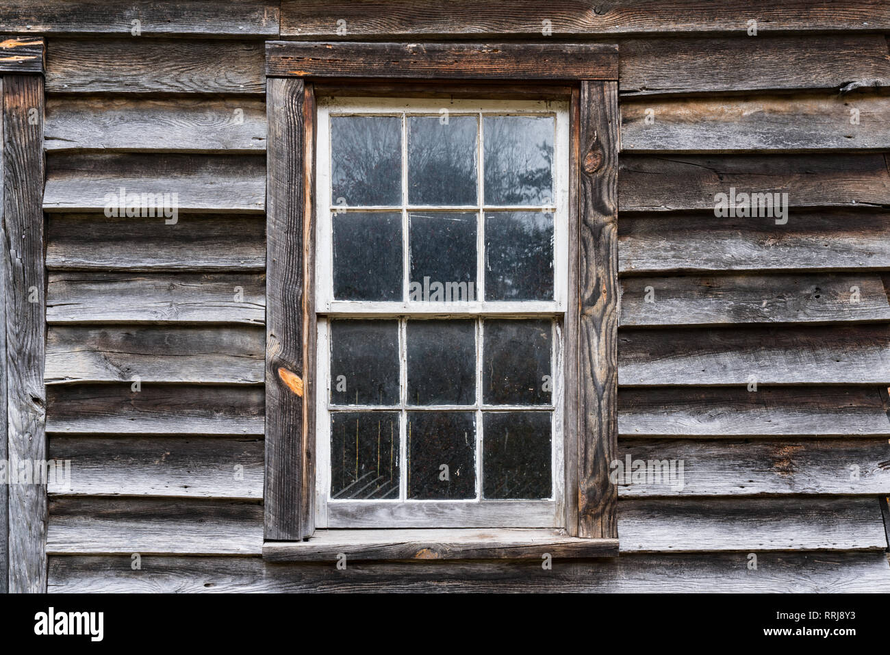 Exterior of old weathered window on rustic building Stock Photo