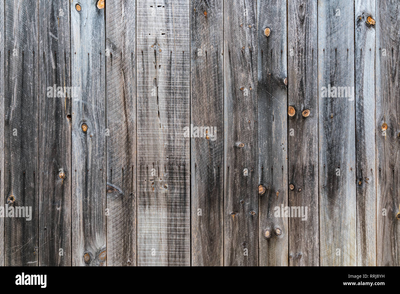 Old rustic weathered wood barn siding background Stock Photo