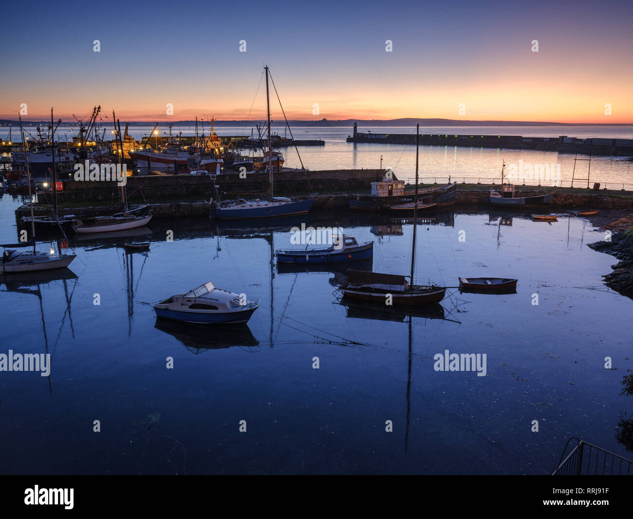 Sunrise looking across the inner and outer harbours at the fishing port of Newlyn, Cornwall, England, United Kingdom, Europe Stock Photo