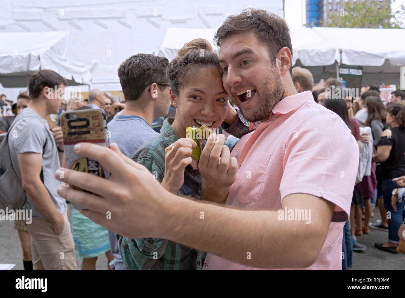 An attractive couple pose with their pickles at the annual Pickle Day
