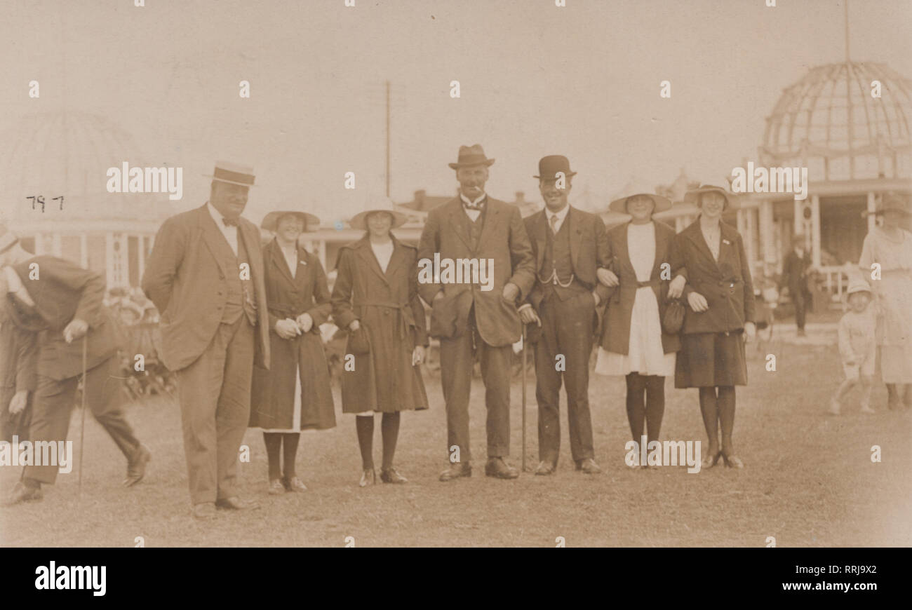 Vintage Photographic Postcard Showing a Group of Smartly Dressed People Enjoying a Sociable Day Out. Stock Photo