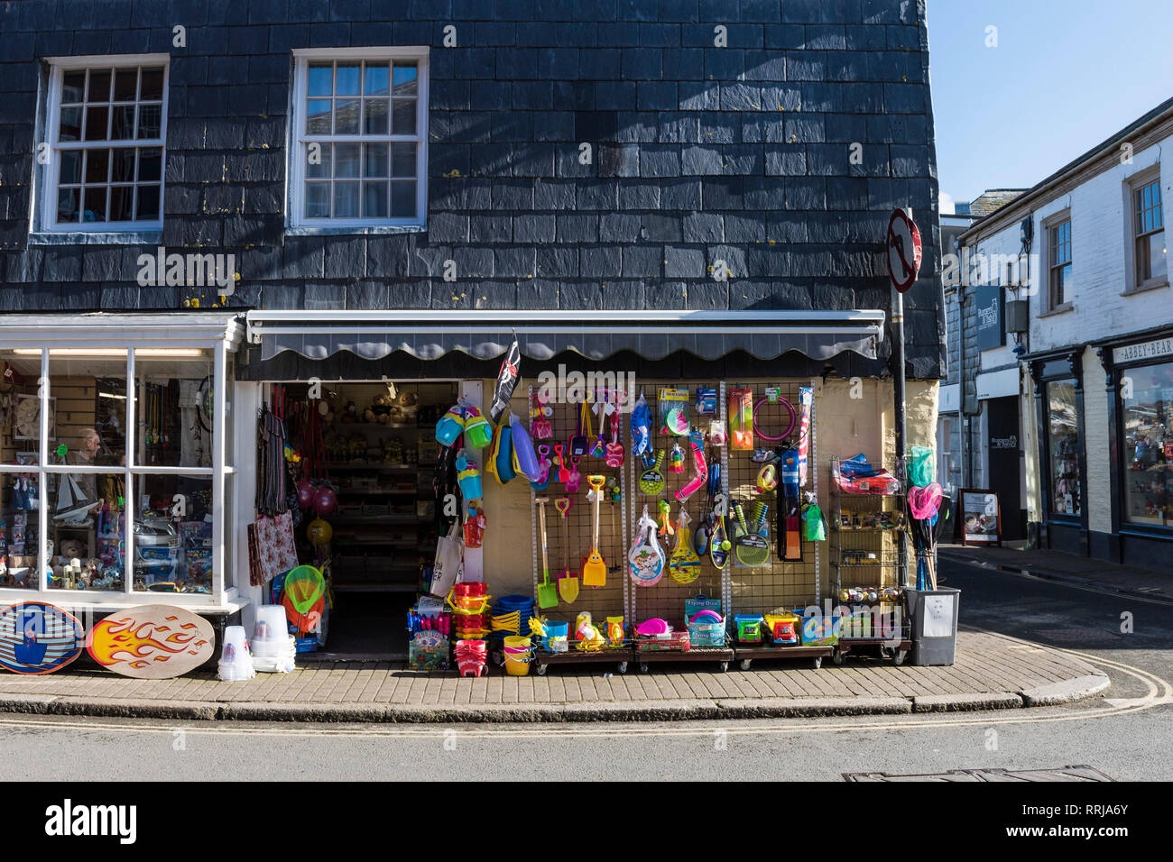 Colourful beach novelty toys hanging outside a shop in Padstow in Cornwall. Stock Photo