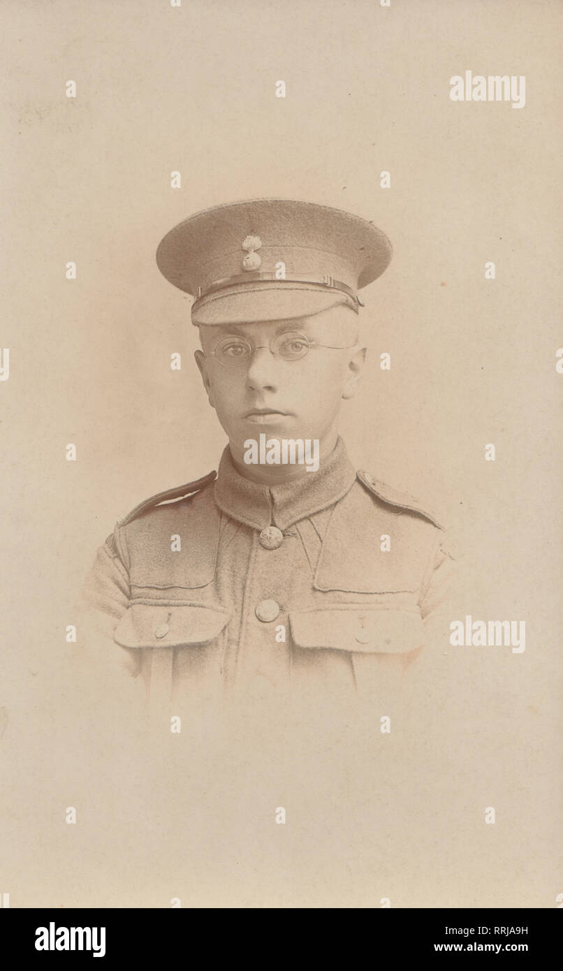 Vintage Photographic Postcard Showing a British WW1 Soldier Wearing Glasses. The Cap Badge Appears To Signify a Fusilier Regiment. Stock Photo