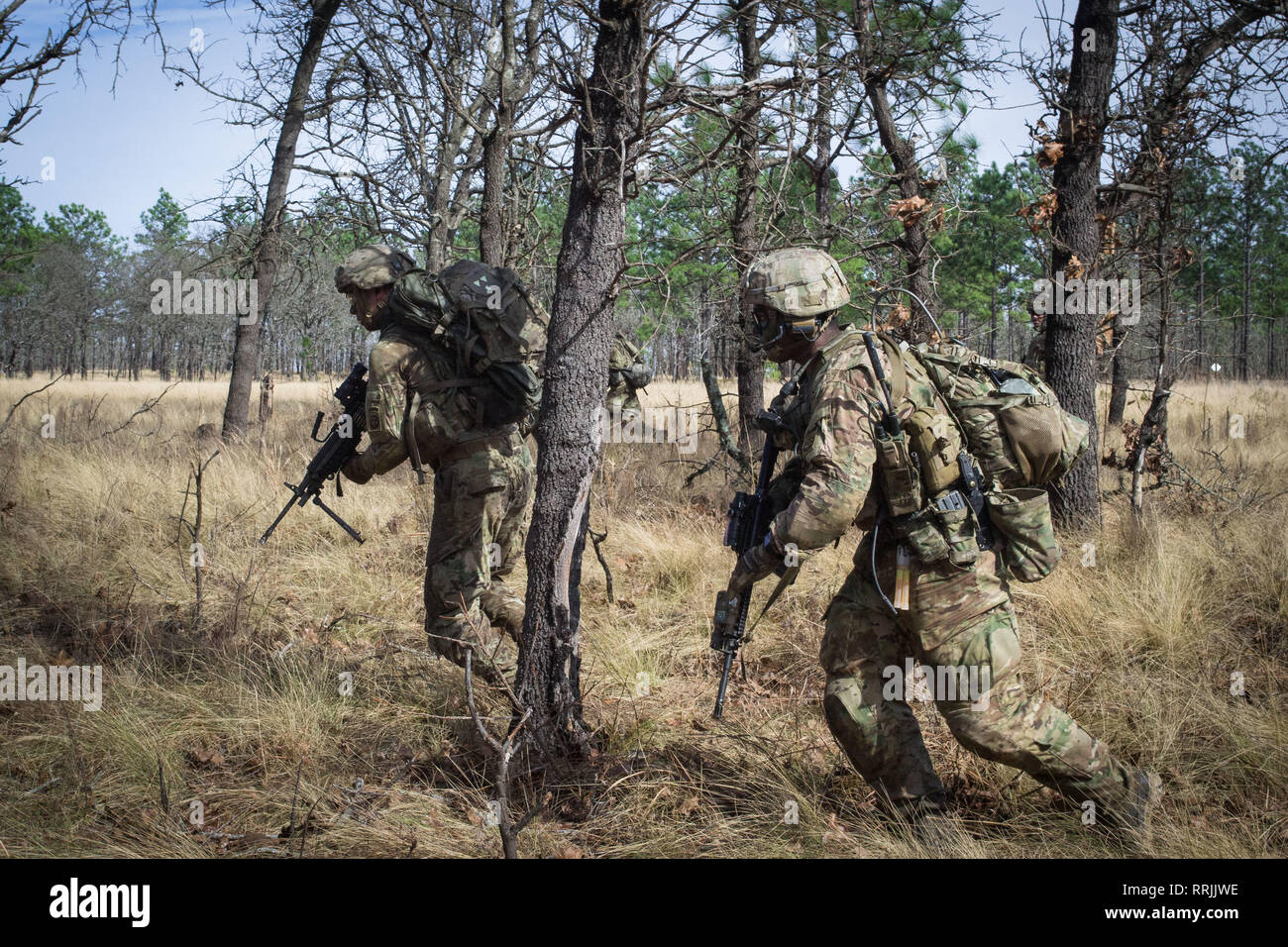 Paratroopers from Company C, 2nd Battalion, 505th Parachute Infantry Regiment, 3rd Brigade Combat Team, 82nd Airborne Division bound between cover during the Company's live-fire exercise held Sunday, February 24 on Fort Bragg, North Carolina. Stock Photo
