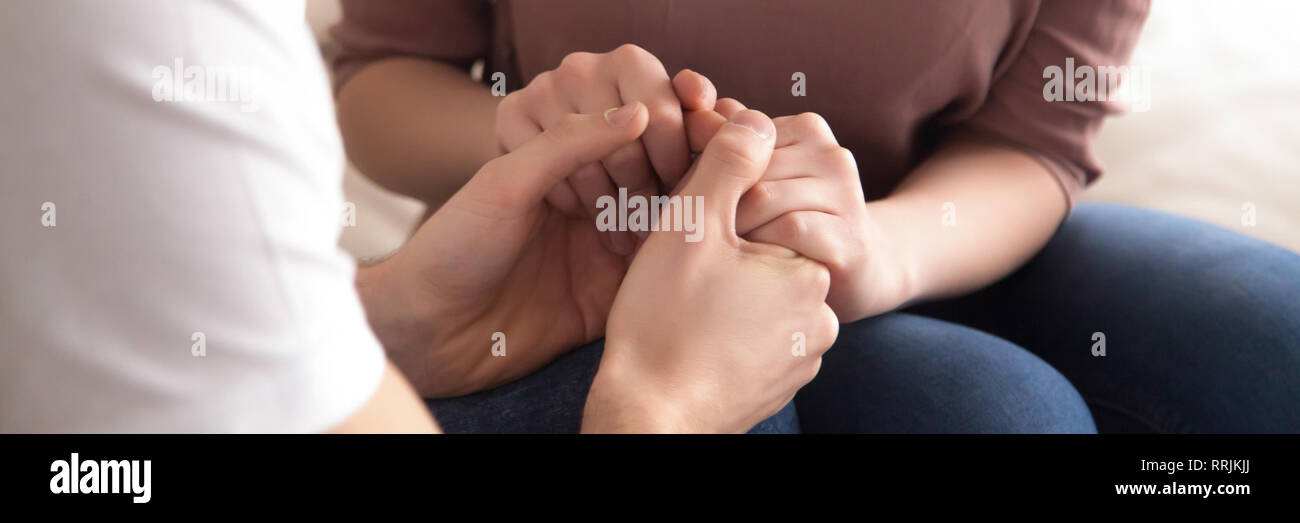 Close up panoramic image caucasian couple in love holding hands Stock Photo