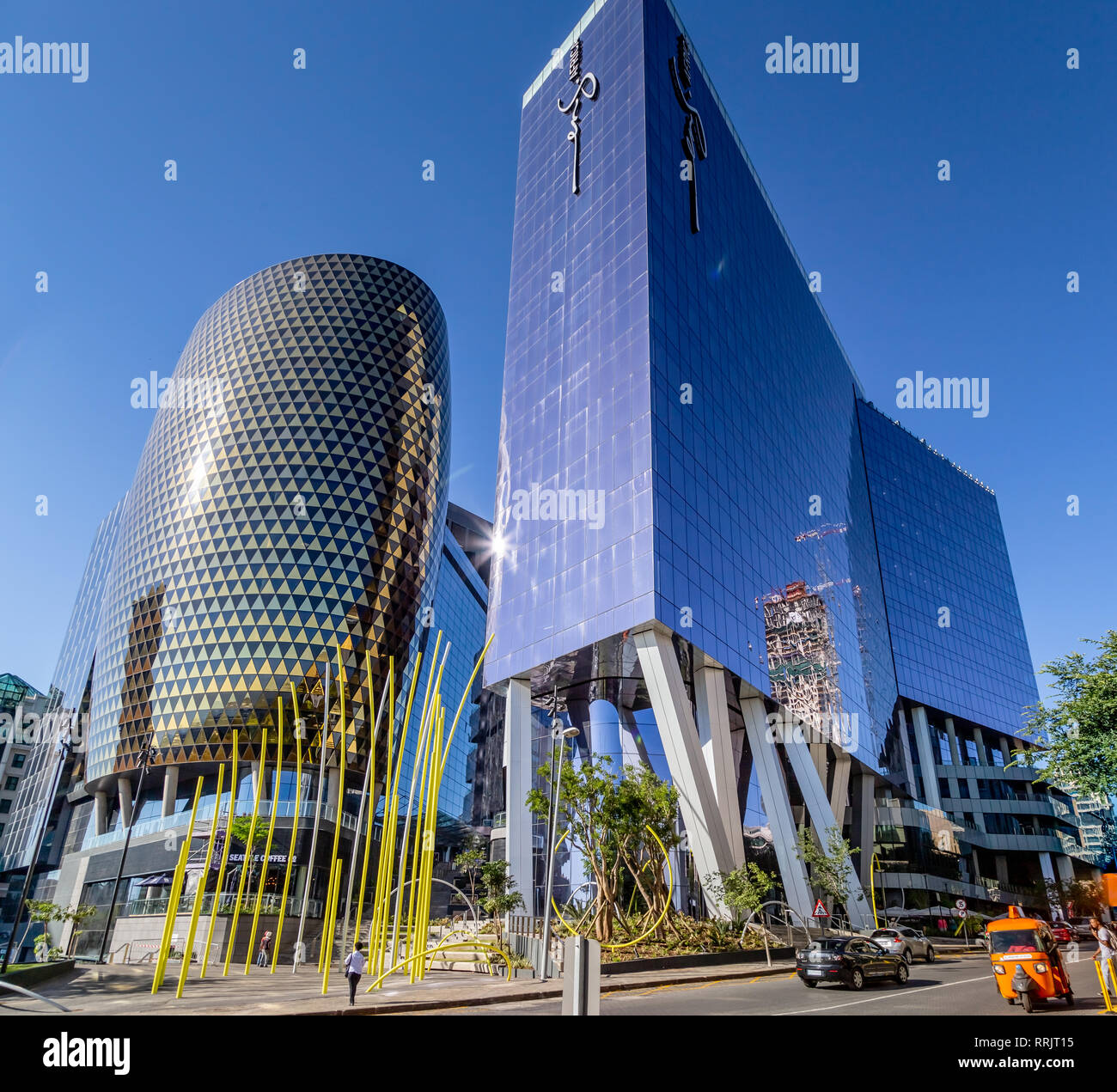 Johannesburg, South Africa, 28 November - 2018: Glass fronted hotel buildings with different coloured glass reflecting in the sun. Stock Photo