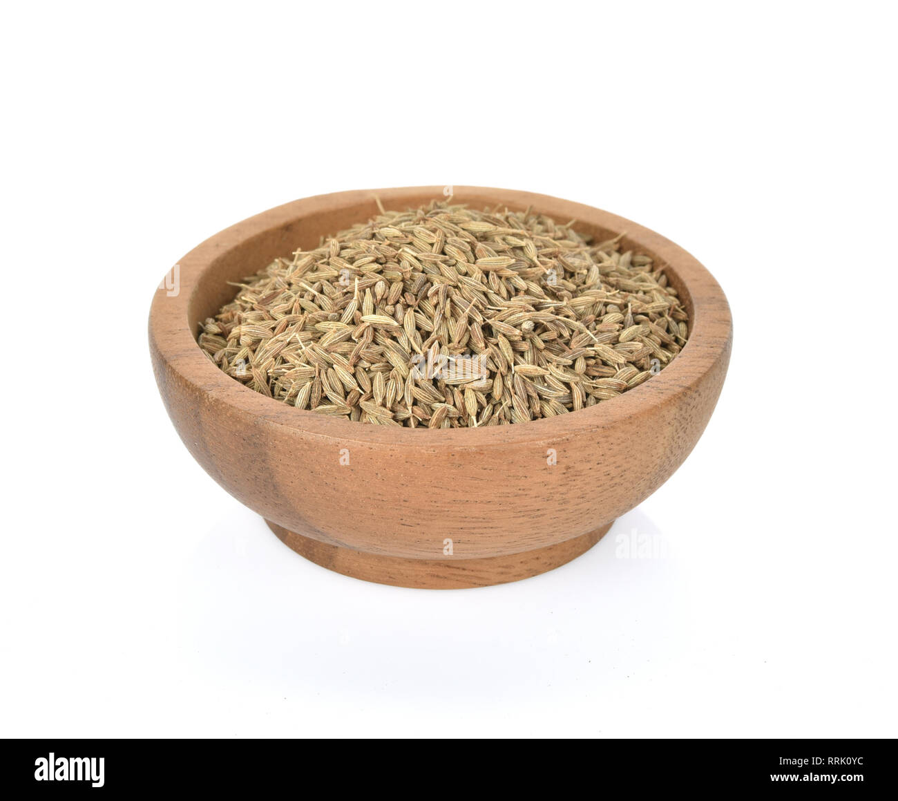 Caraway seeds in wooden bowl on white background Stock Photo