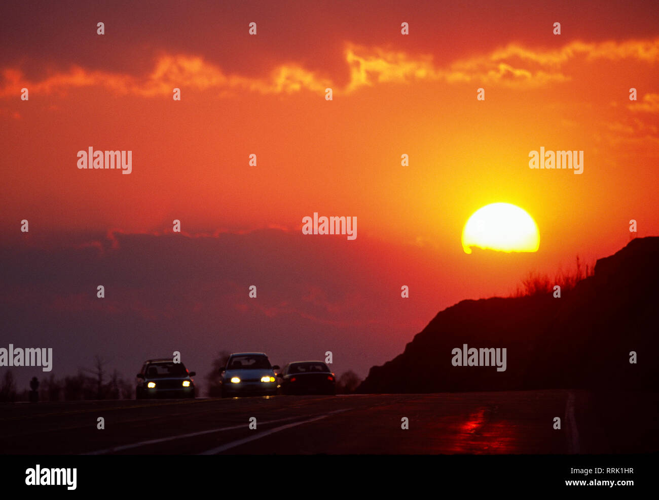 Sun setting behind cars on Highway 17, Sudbury, Ontario. Canada Stock Photo