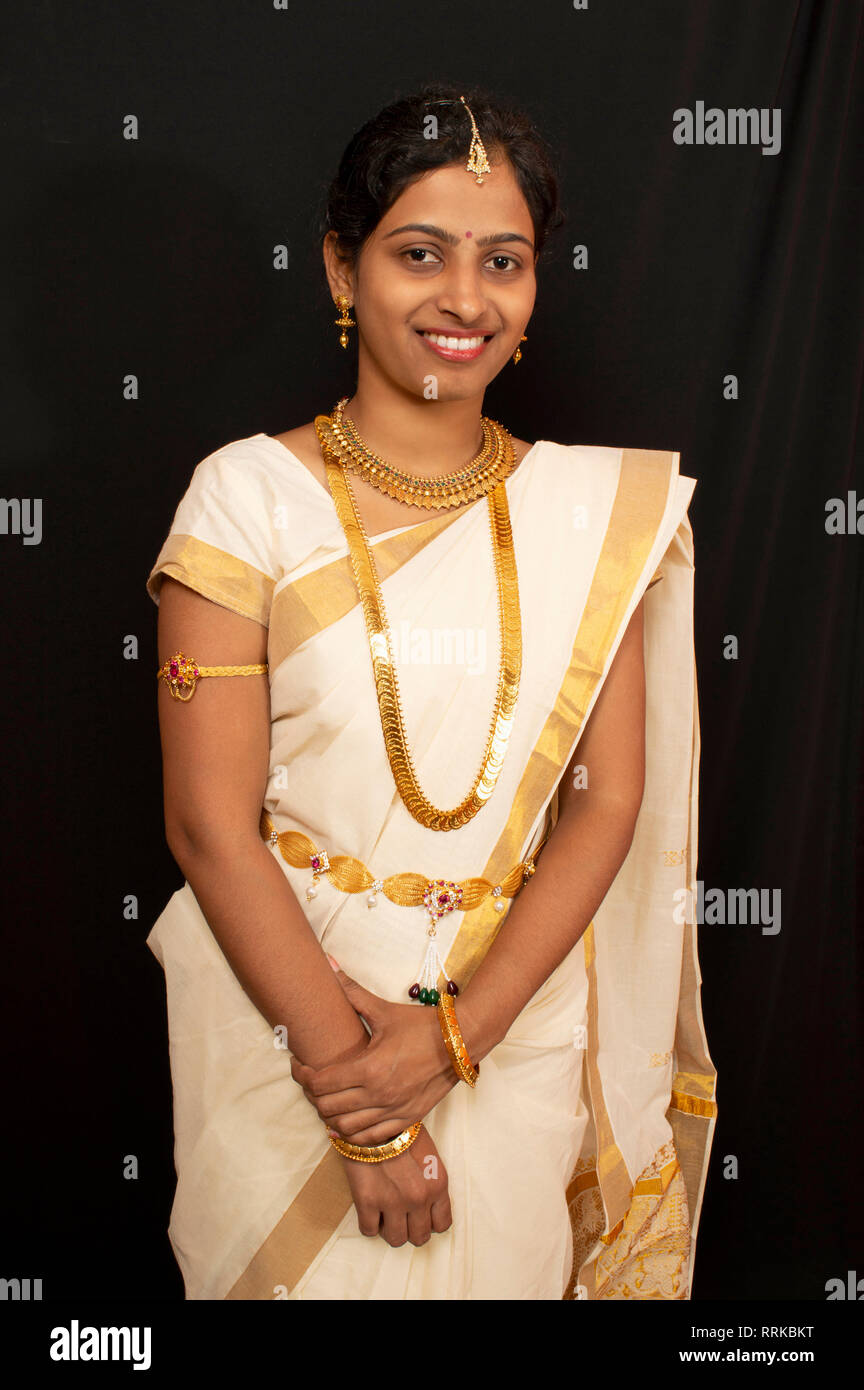 young girl in traditional kerala saree and jewelry RRKBKT