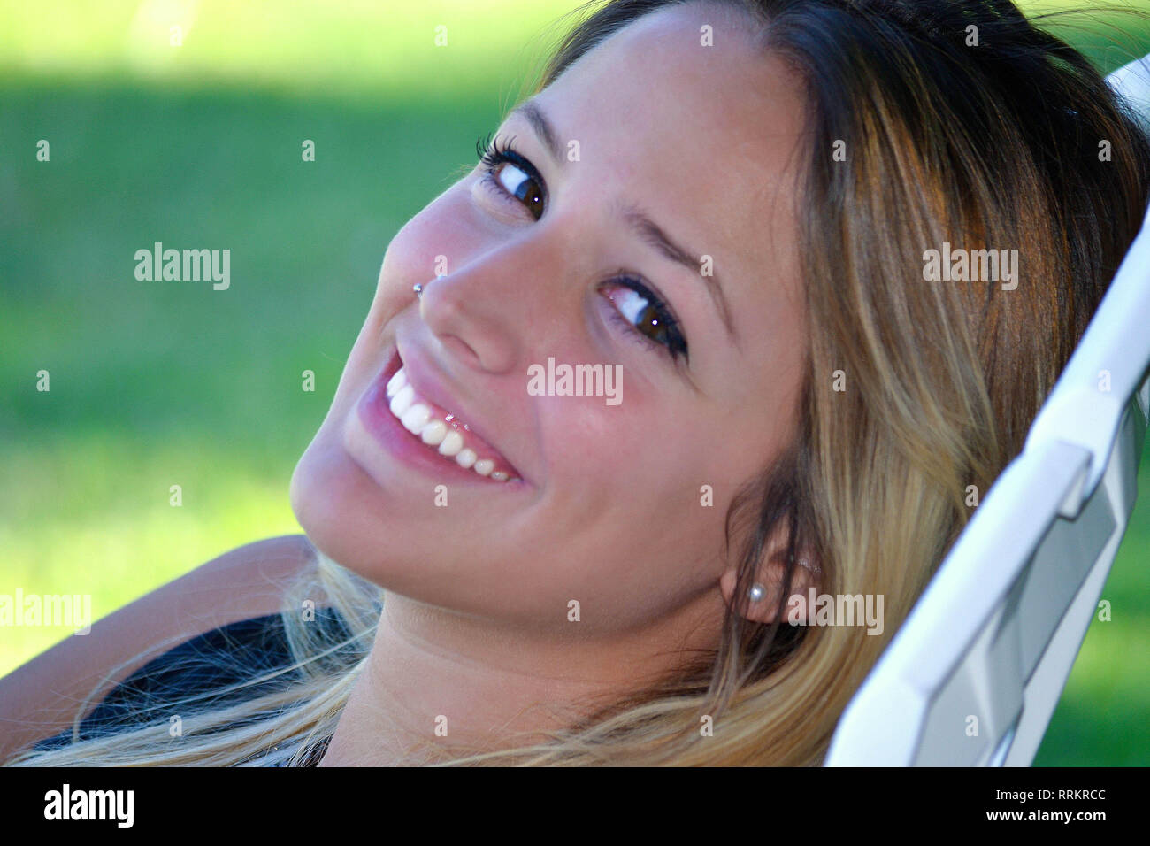 Beautiful young woman teenager smiling at camera happy Stock Photo