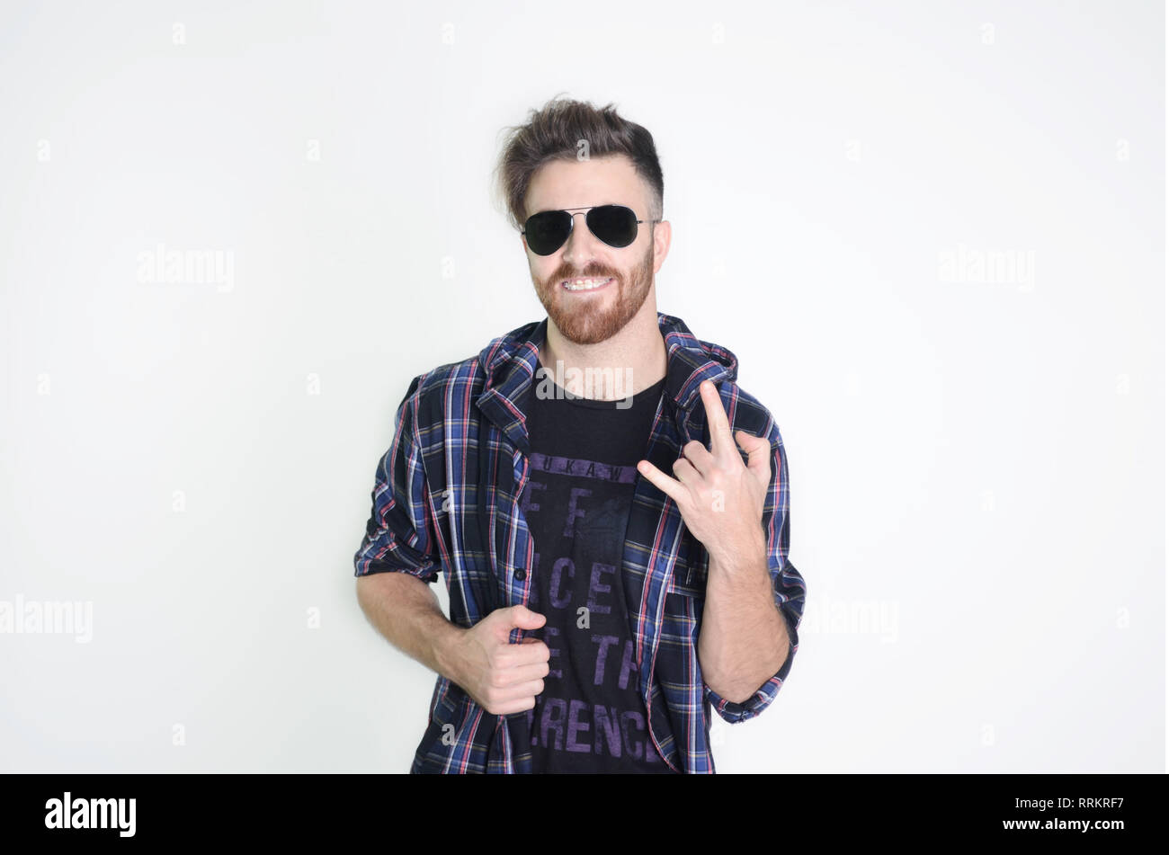 Young man posing happy and confident with sunglasses on isolated white ...