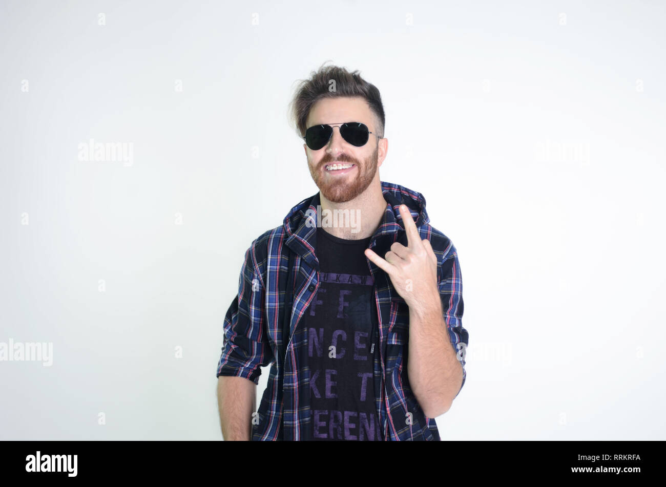 Young man posing happy and confident with sunglasses on isolated white ...