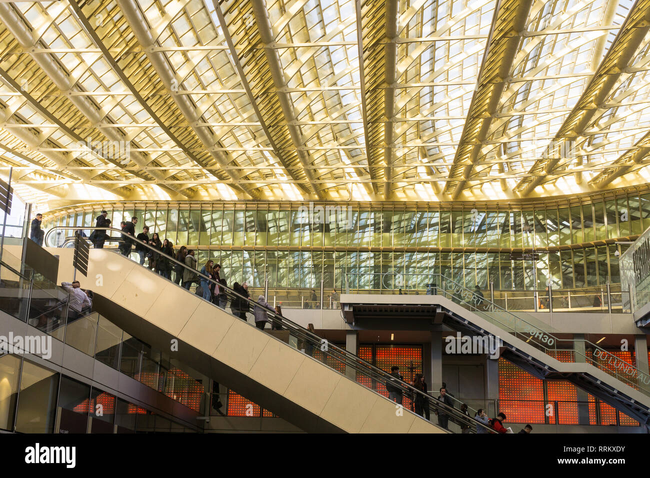 People riding escalators at Forum des Halles mall in Les Halles area of Paris, France. Stock Photo