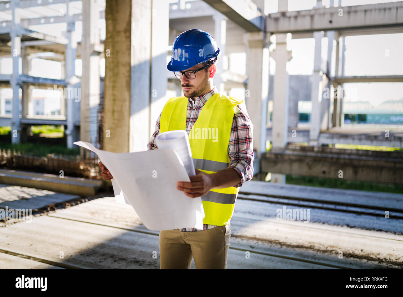 Picture of construction site engineer looking at plan Stock Photo - Alamy