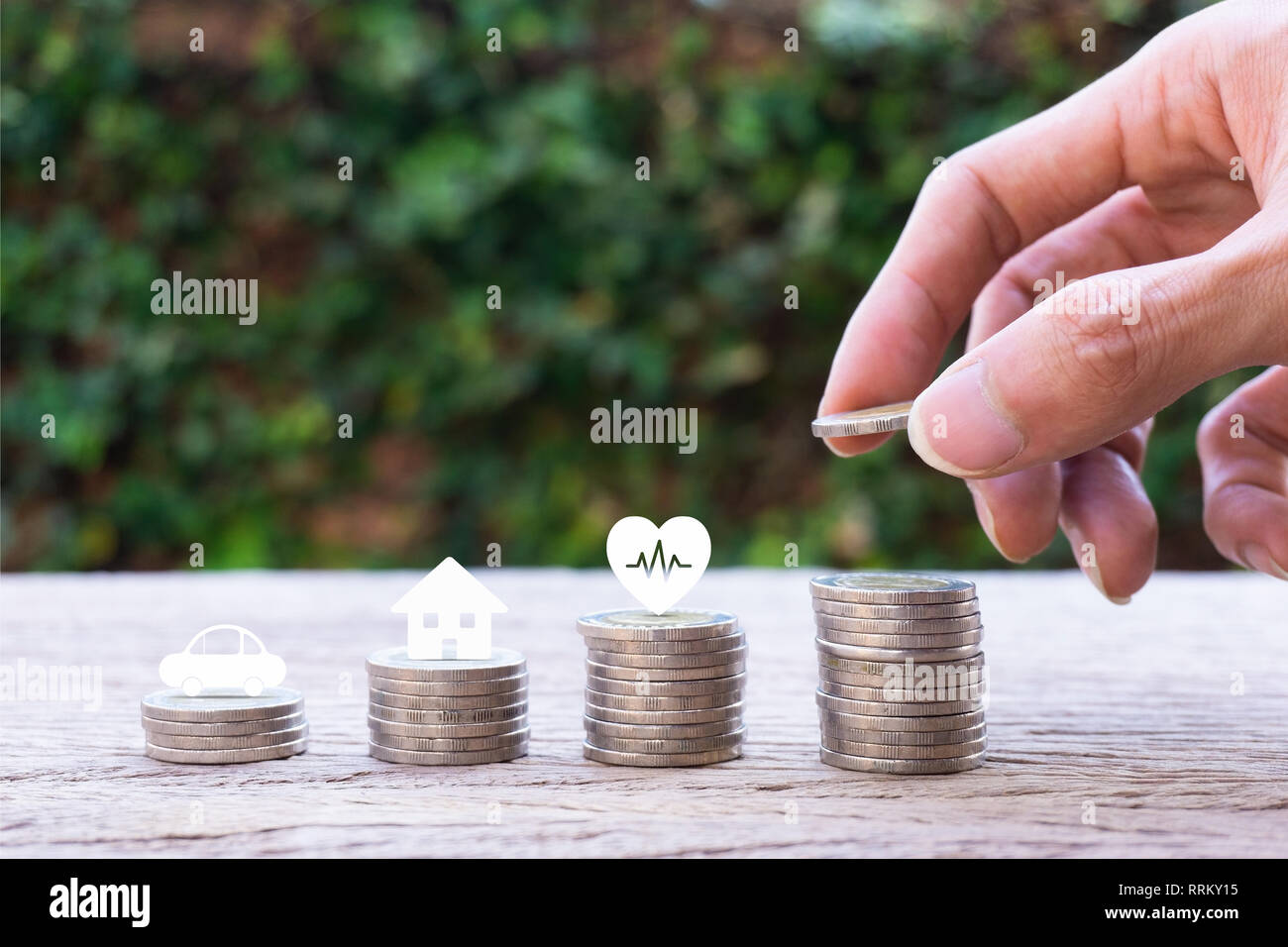 Savings money for life future concepts. Hand holding coin over stacked