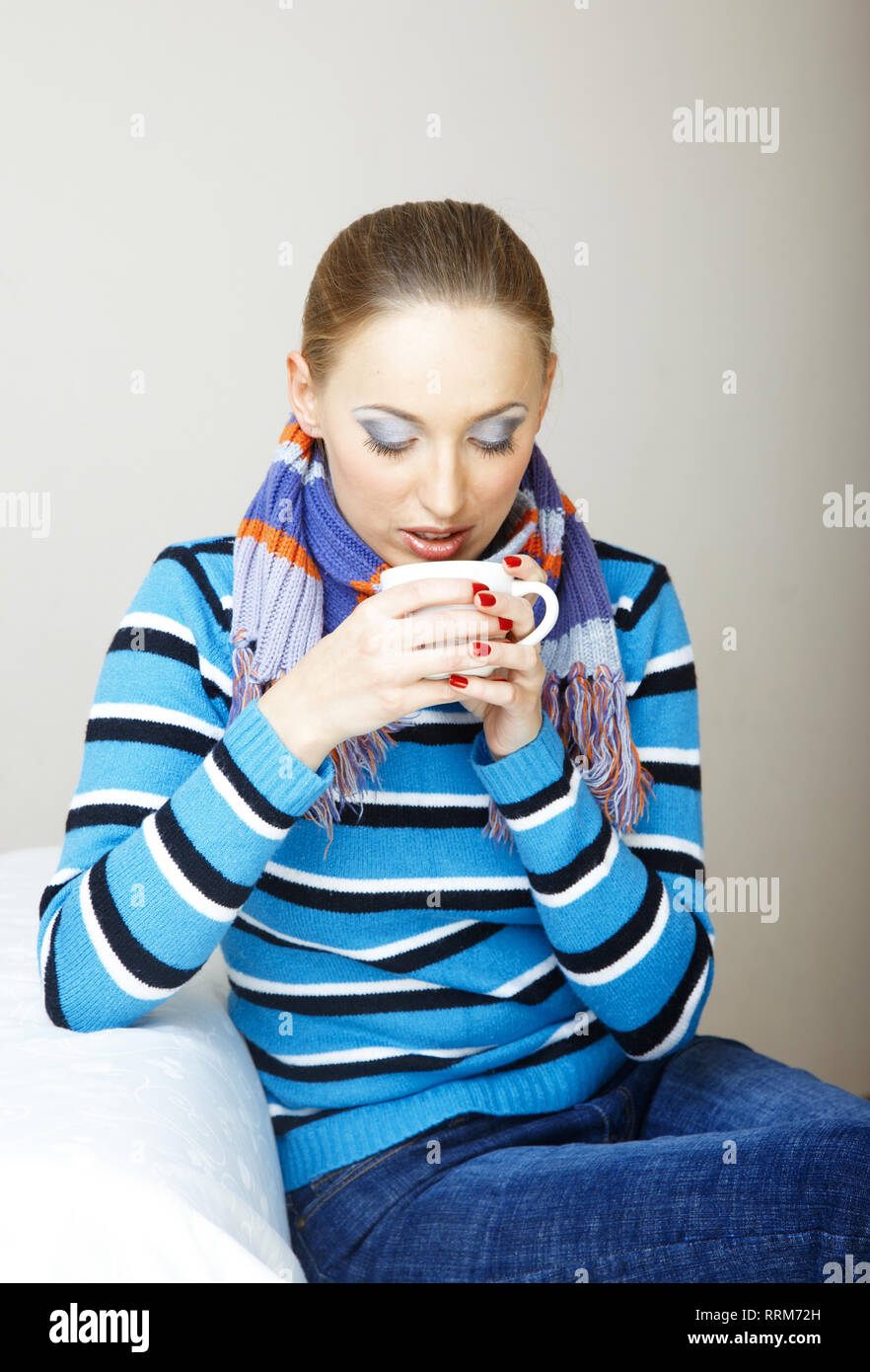 Sick woman drinking hot tea. Indoors photo Stock Photo