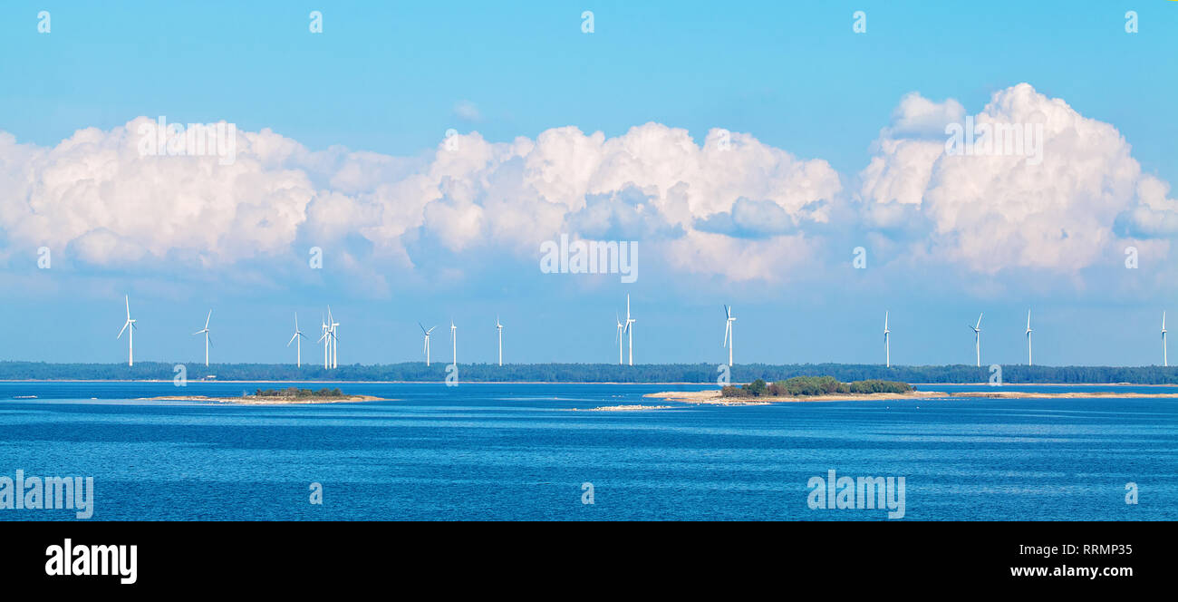 Wind farm nature background with wind turbine, blue sky and sea. Wind turbine landscape Stock Photo