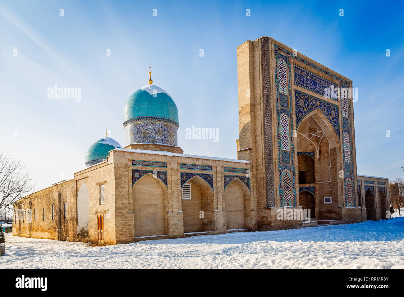 Decorated entrance and two domes of Hazrati Imam complex, religious center of Tashkent, winter time, Uzbekistan Stock Photo