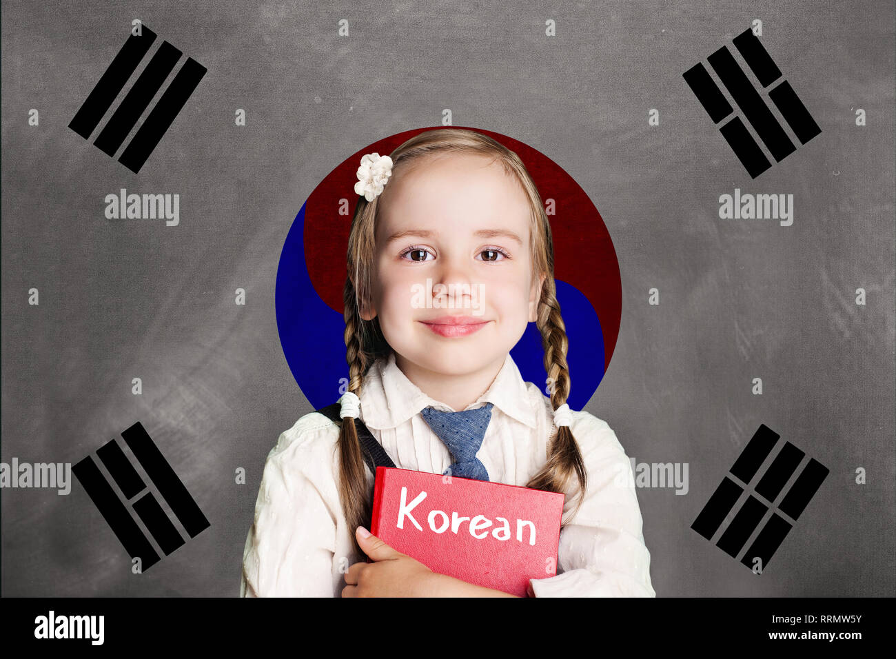 Happy child girl pupil with book against the South Korea flag background. Learn korean language, South Korea concept Stock Photo