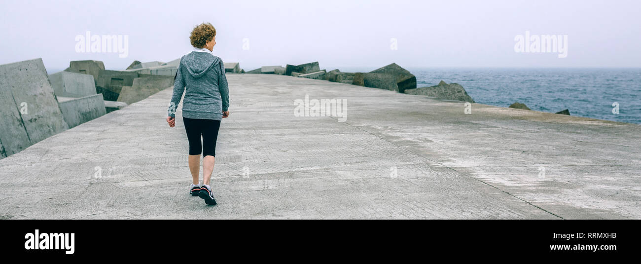 Back view woman walking sea hi-res stock photography and images - Alamy