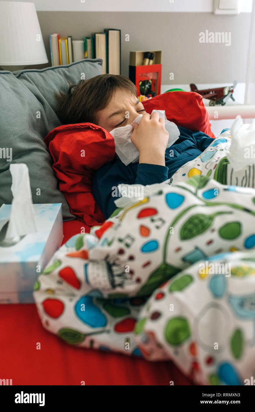 Cold child lying on the bed Stock Photo Alamy