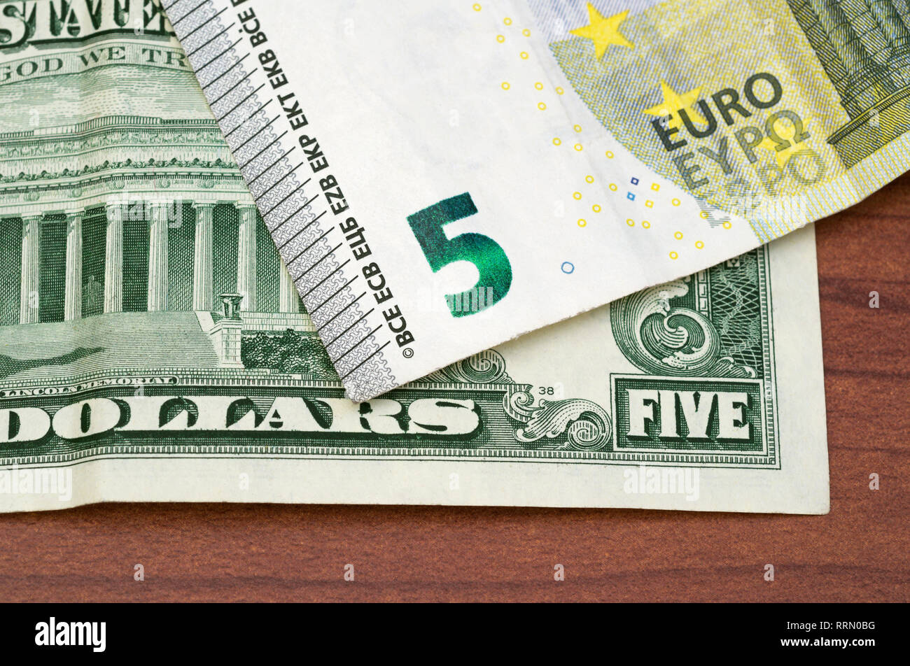 5 US dollars and 5 Euro Stock Photo