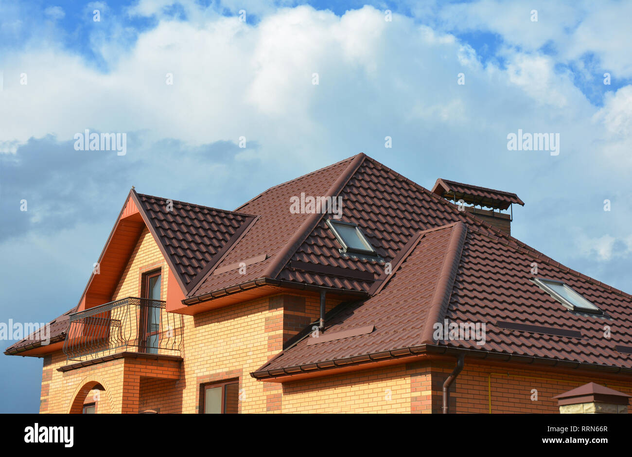 New roofing construction with attic skylights, rain gutter system, roof  windows and roof protection from snow board, snow guard house exterior  Stock Photo - Alamy