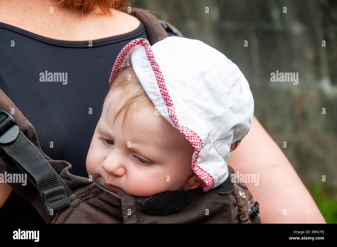 Mother Carrying Sleeping Daughter In Baby Carrier Stock Photo Alamy