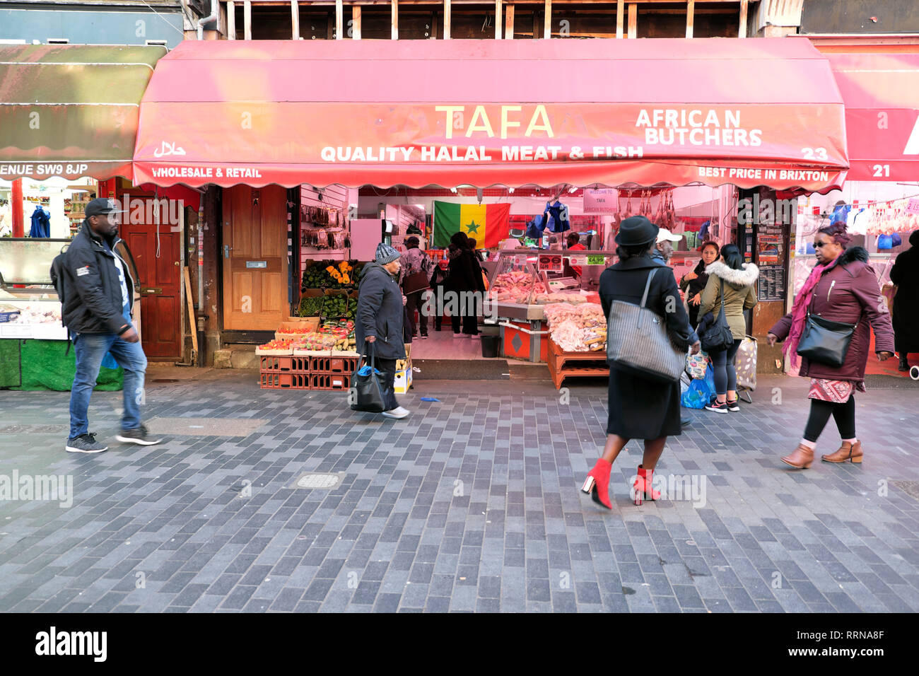 Shoppers by Tafa African Butchers selling Halal meat & fish at Brixton