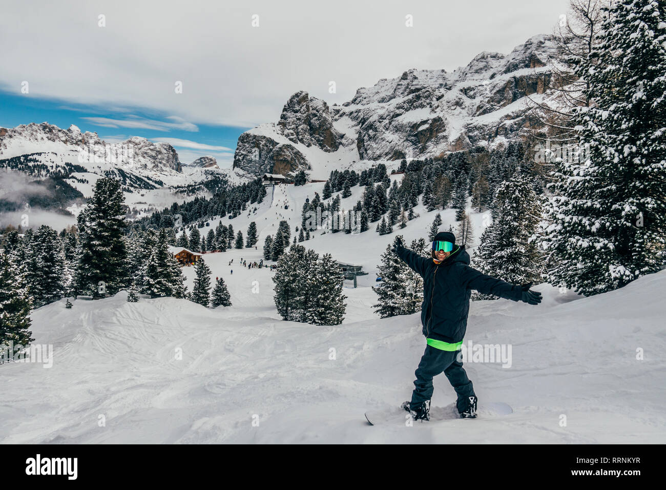 Portrait exuberant snowboarder on snowy ski slope, Dolomites, Italy Stock Photo