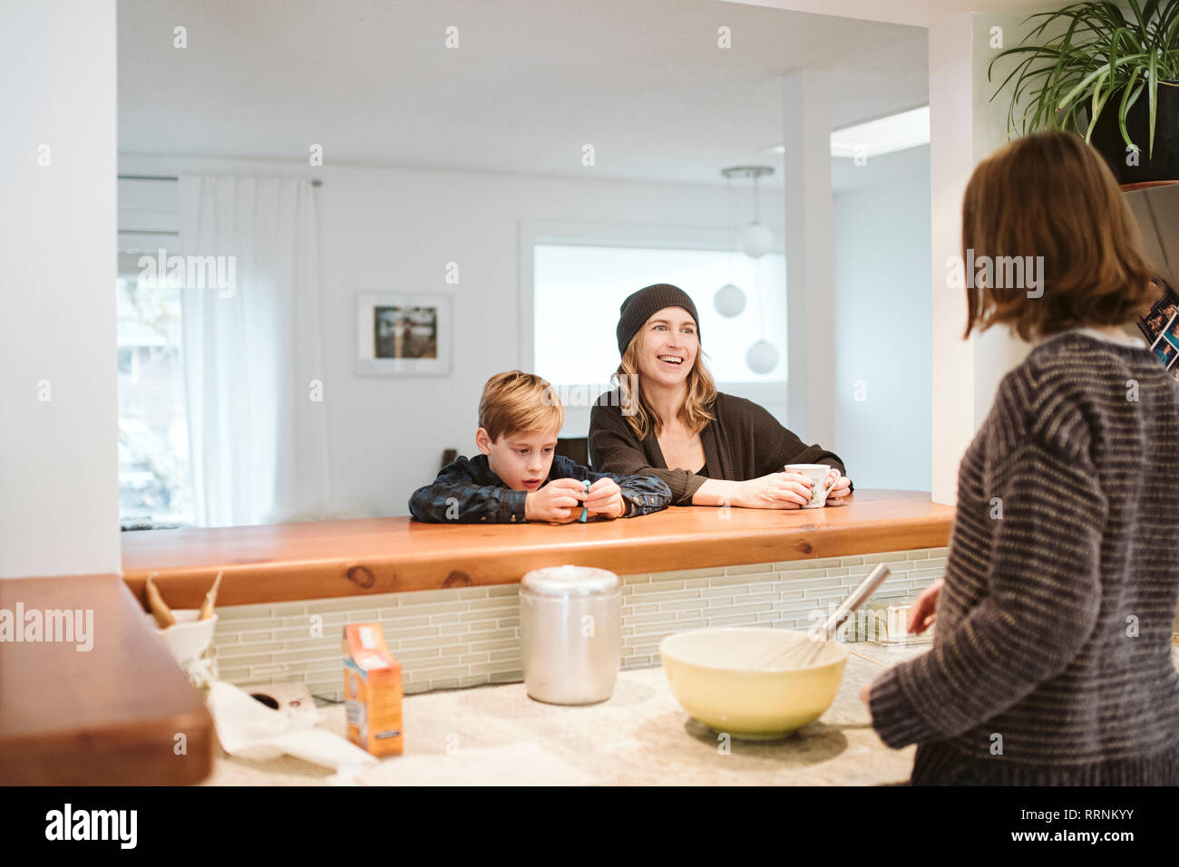 Family baking and talking in kitchen Stock Photo