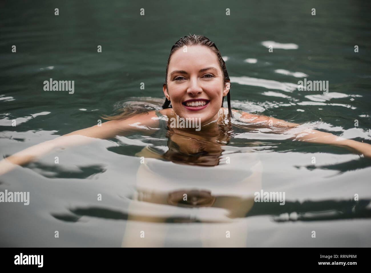 Young woman swimming into lake hi-res stock photography and images - Alamy