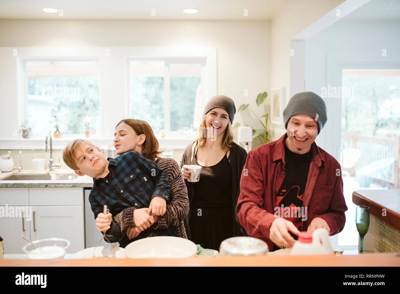 Portrait happy, playful family baking in kitchen Stock Photo