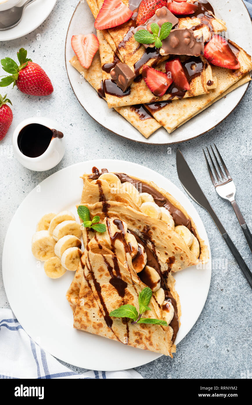 Crepes with chocolate, banana and strawberry. Top view. Tasty European or French style breakfast, table top view Stock Photo