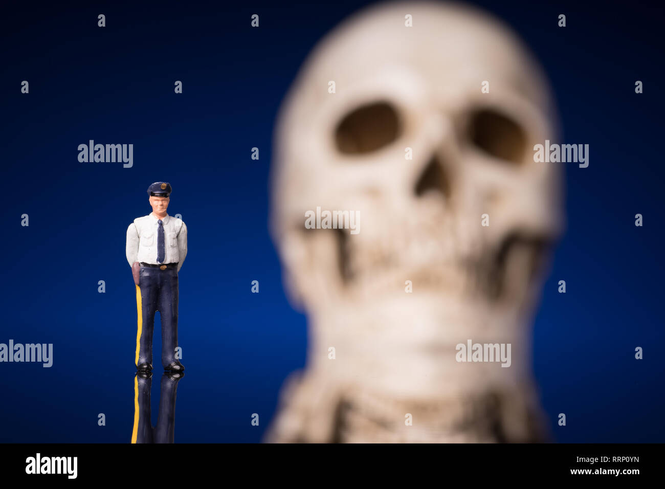 Police and blurry skull isolated om blue black background Stock Photo