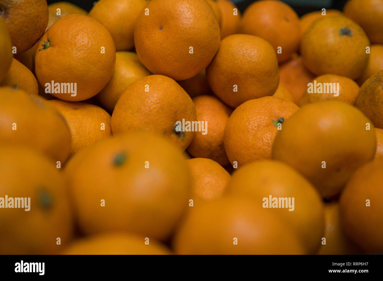 Fruit background. Small ripe orange tangerines. Vitamin complex Stock
