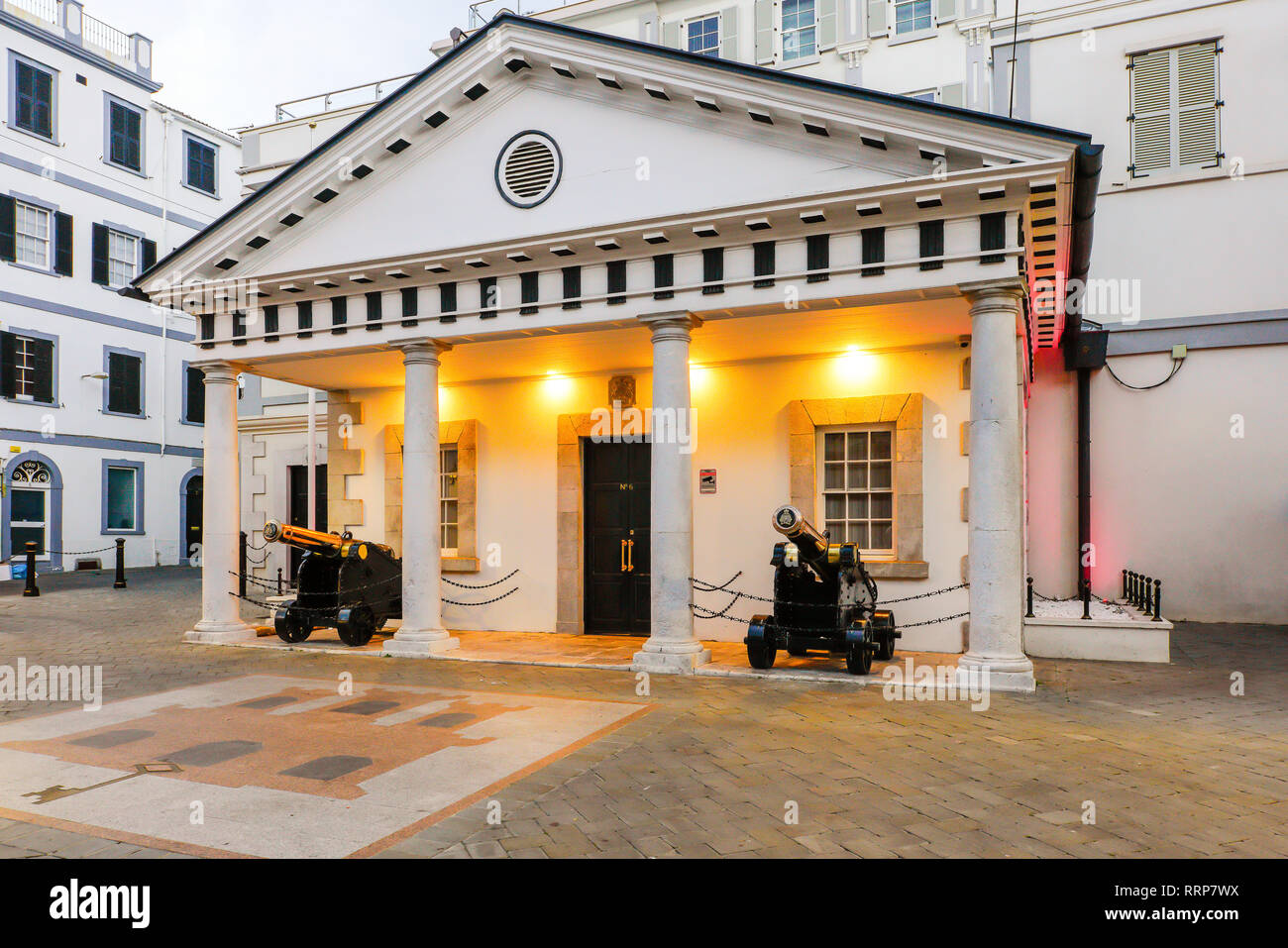 Street view of Government building on Main street, with two cannons, Gibraltar, British Overseas Territory. Stock Photo
