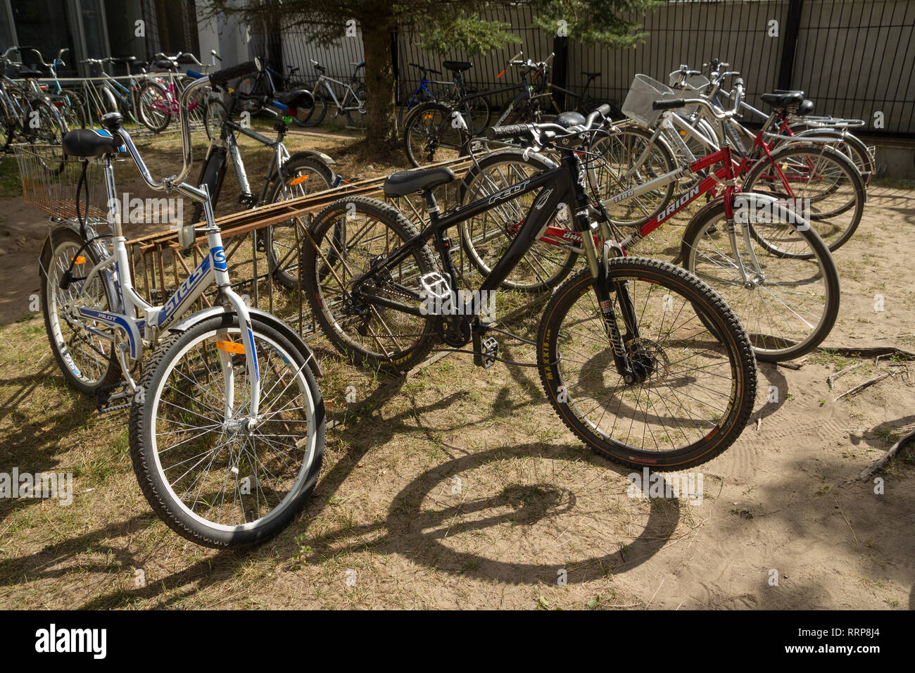 Dubna, Russia - Jul 21, 2014: Bicycles at bike-stand near the Tensor factory. Stock Photo