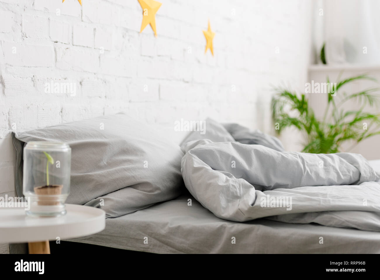 Cozy light bedroom with bed and green plants Stock Photo Alamy
