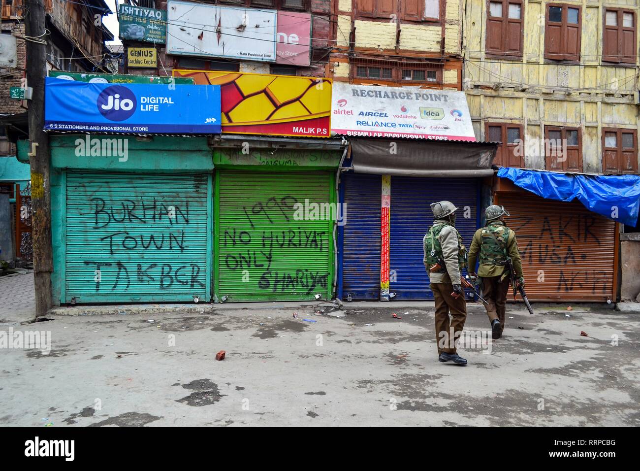 Government forces stand alert outside the house of the top separatist leader Yasin Malik, during a raid by Indian Intelligence officers in Srinagar, Kashmir. The National Investigation Agency (NIA) Tuesday carried out searches on top separatist leaders in Kashmir valley in a terror funding case, officials said. The NIA officials were accompanied by local police and CRPF. Meanwhile, clashes erupted in Maisuma locality soon after sleuths of National Investigations Agency carried out raids on top separatist leaders. Stock Photo