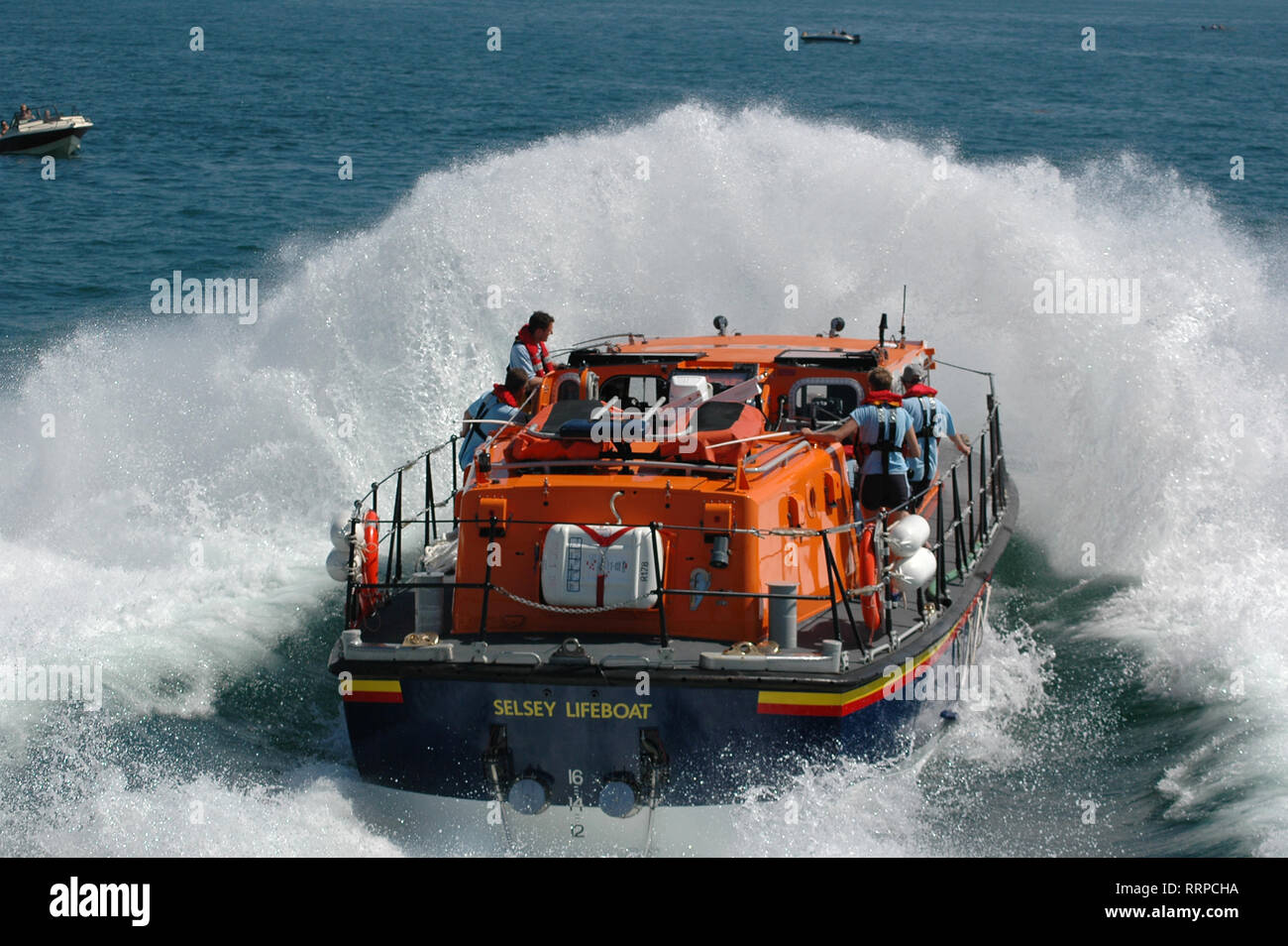 RNLI all weather Tyne class Lifeboat 'Voluntary Worker' hitting the water in a demonstration launch at Selsey Lifeboat launch Day. Stock Photo