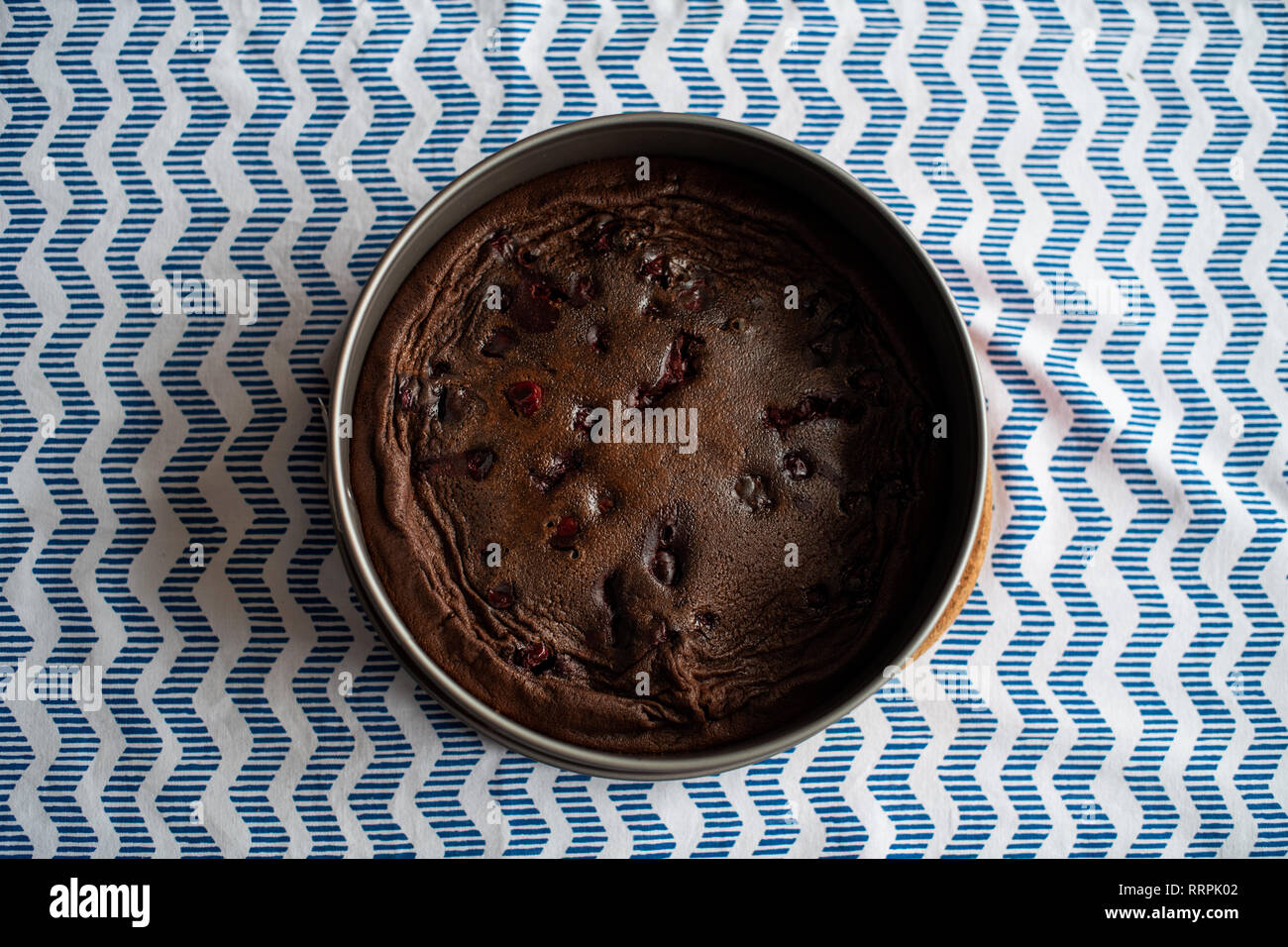 baked chocolate cake with cherries, made without flour Stock Photo