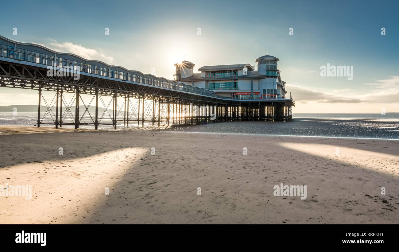 Weston-super-Mare, North Somerset, England, UK - October 04, 2018: The setting sun over the beach and the Grand Pier Stock Photo