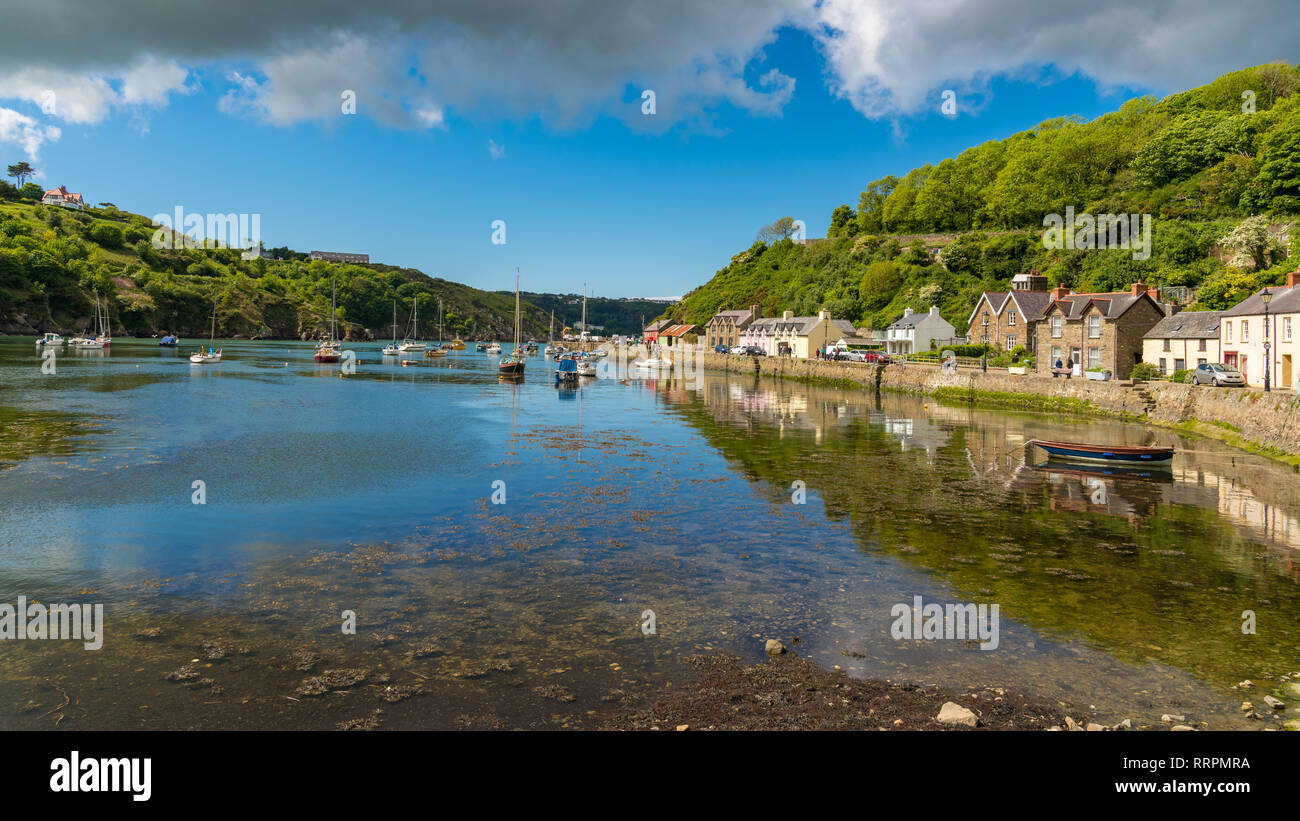 Fishguard, Pembrokeshire, Wales, UK - May 20, 2017: Boats in the Marina, with people walking on Quay Street in the background Stock Photo