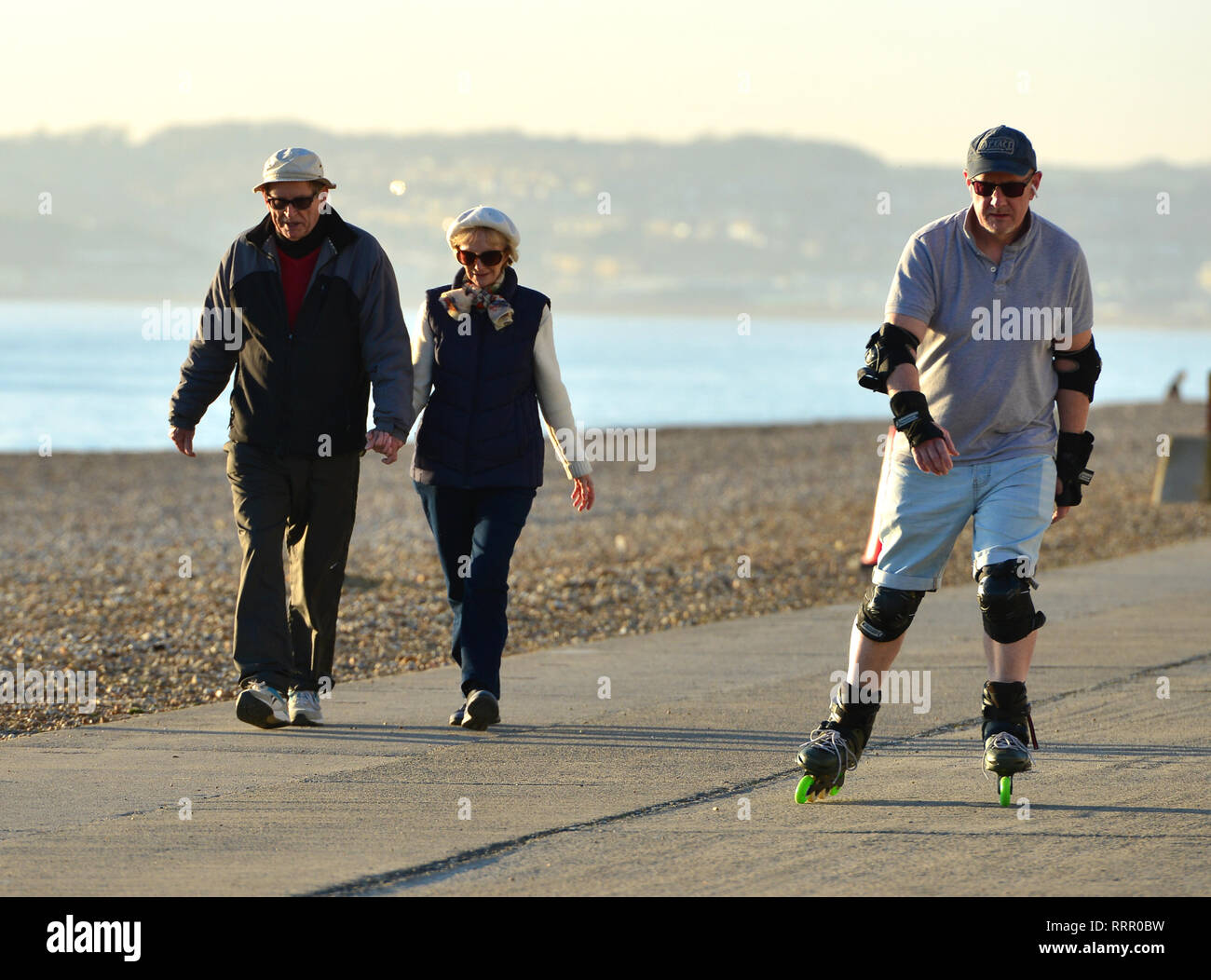 Seaford, East Sussex, UK. 26th Feb, 2019. People enjoying the warm sun in Seaford, East Sussex, on the hottest winter day on record. Credit: Peter Cripps/Alamy Live News Stock Photo