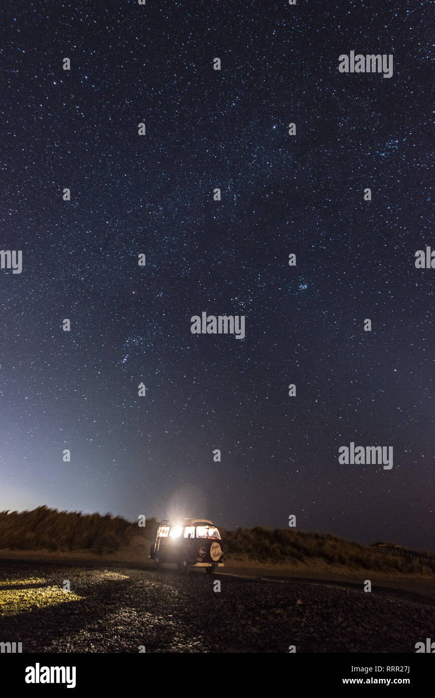 Ynyslas Nature reserve Ceredigion, Wales UK, Tuesday 26 February 2019. After a day of record-breaking high February temperatures in west Wales, the clear dark skies over a classic VW Type 2 camper van parked up at the Ynyslas Nature Reserve on the Dyfi estuary reveal the magnificece of the Milky Way.  photo credit: Keith Morris / Alamy Live News Stock Photo